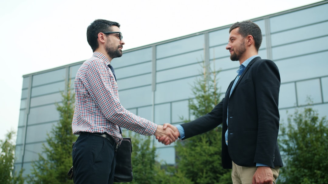 Home Business partners shaking hands after a successful collaboration